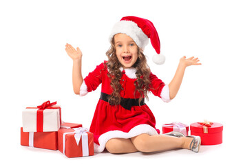 Cute little girl in Santa costume and with gift boxes on white background