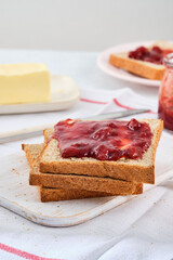 Toast with butter and strawberry jam. Tasty breakfast.