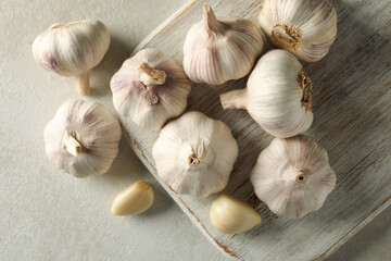 Raw garlic on light background, top view