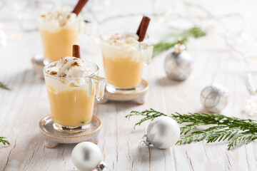 Eggnog with cinnamon and nutmeg for Christmas and winter holidays. - obrazy, fototapety, plakaty
