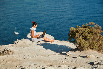 Lady work on laptop from vacation. Nature view and fresh air. Remote office and travel time idea. Freelance job concept