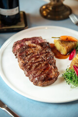 Cut grilled beef ribeye steak with potatoes