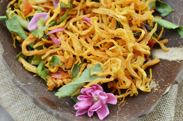 Peach flower blooming and special dried chicken in wood bowl