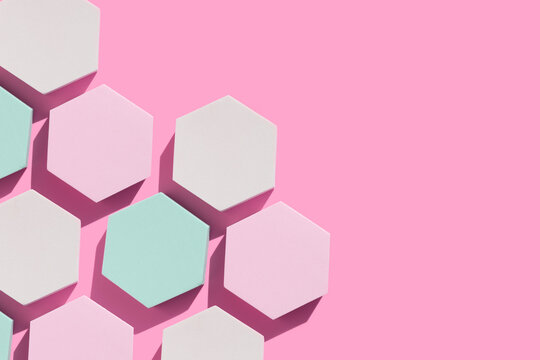 hexagon podiums with prominent shadow on a pink background