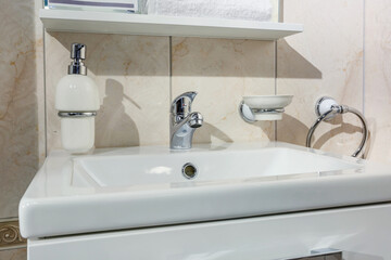 Ceramic Water tap sink with faucet with soap and shampoo dispensers in expensive loft bathroom or kitchen