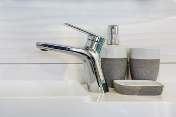 Ceramic Water tap sink with faucet with soap and shampoo dispensers in expensive loft bathroom or kitchen