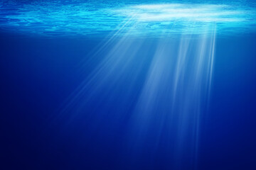 Abstract image of Tropical underwater dark blue deep ocean wide nature background with rays of...