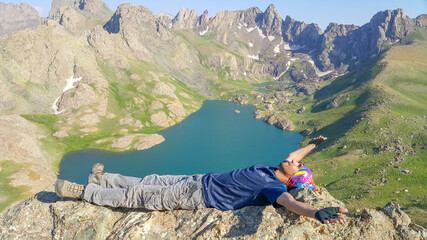 Fototapeta premium A man on the mountain top and lake view, natural landscape 