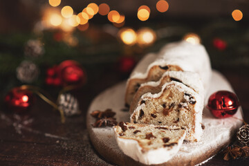 Traditional German Christmas cake - Cranberry Stollen, Christmas tree, ornaments, and candles.