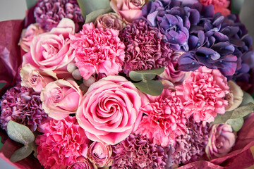 purple and pink bouquet of beautiful flowers on wooden table. Floristry concept. Spring colors. the work of the florist at a flower shop.