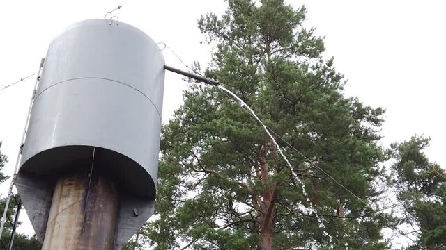 Excess water is poured out of the water tower. slow motion
