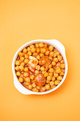 chick-pea with smoked sausage in white bowl