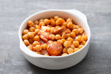 chick-pea with smoked sausage in white bowl