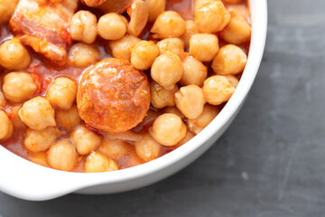 chick-pea with smoked sausage in white bowl