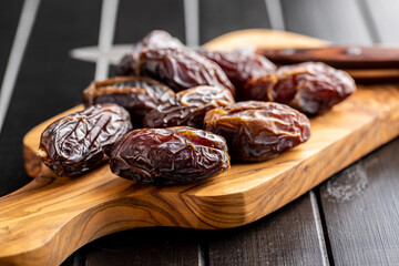 Dried dates fruit on cutting board.