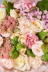 Beautiful spring bouquet on wooden table.. Arrangement with various flowers. The concept of a flower shop. A set of photos for a site or catalogue. Work florist.