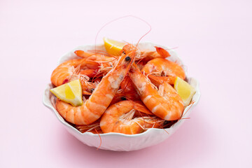 boiled shrimps with fresh lemon in white bowl