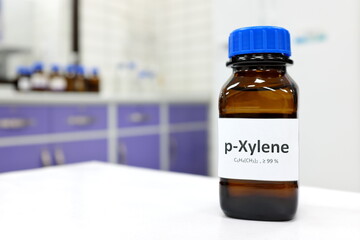 Selective focus of xylene liquid chemical compound in dark glass bottle inside a chemistry...