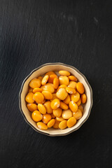 salted lupins in small light brown bowl