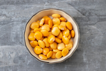 salted lupins in small light brown bowl on ceramic background