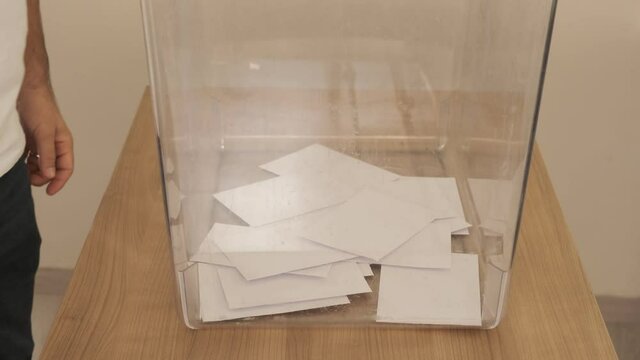 citizen voting in transparent box.