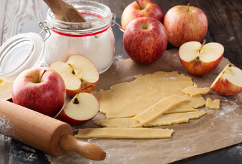 Cooking baking concept. Making rustic American style apple pie, view on table with ingredients.