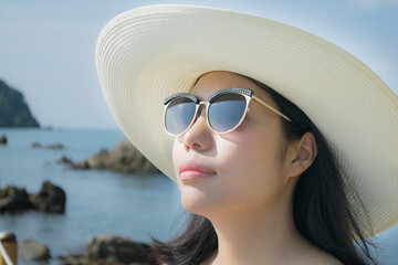 portrait of a woman in sunglasses on the beach