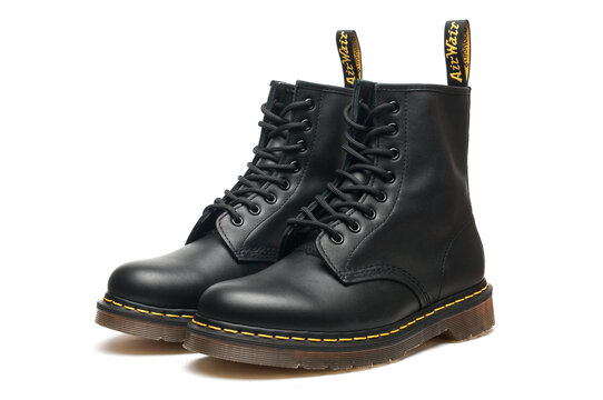 A pair of leather Dr. Martens Air Wair boots on white background