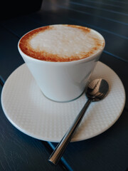 A Cup of coffee is on the table