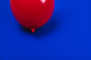 Red balloon on blue background.