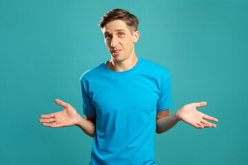 Doubtful man. Careless gesture. Helpless emotion. Unsure look. Astonished skeptic young guy...