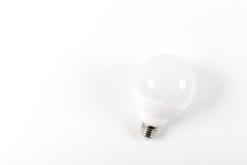 Banner with a big matte light bulb isolated on white background and have free place for text. Development of energy efficient and energy saving light bulbs. The temperature of the light