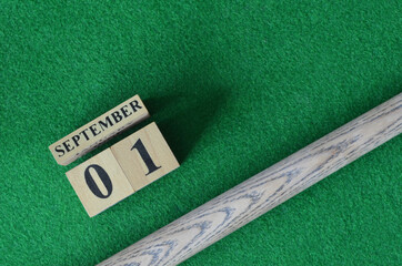 September 1, Number cube with a snooker stick on a green background, snooker table.