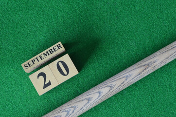 September 20, Number cube with a snooker stick on a green background, snooker table.