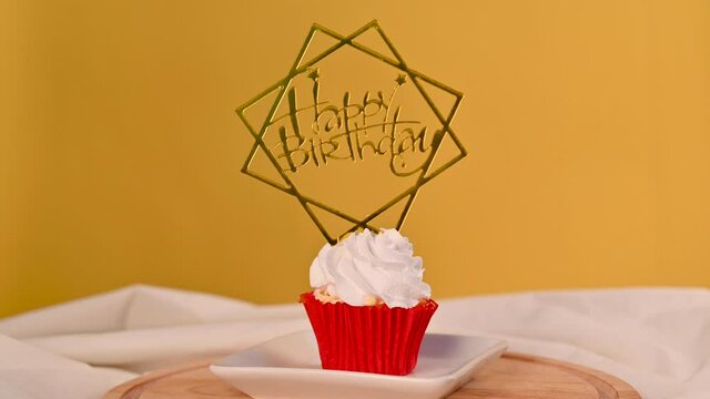 Cupcake birthday,Woman's hand Pin a Happy Birthday badge on the cupcakes.anniversary concept