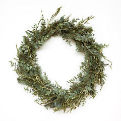 Round wreath frame made of fir and eucalyptus branches on white background. Christmas / New Year celebration decoration. Holiday concept.