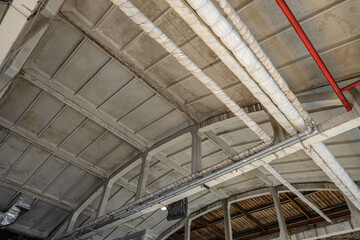 Ribbed slabs cover plates on reinforced concrete roof truss an industrial building with laid overhead engineering pipelines