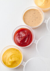 Different types of sauces on a white background