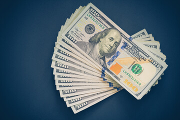100 american dollars on black background