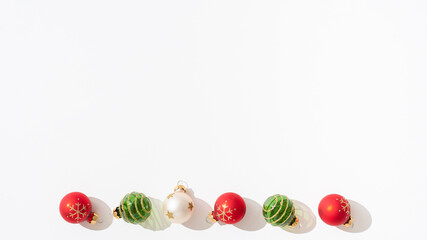 Christmas banner, poster, greeting card background. Colorfull christmas balls Ornaments on white backdrop. Minimal christmas concept. New year minimalism. Top view, copy space.