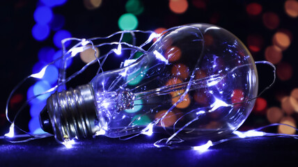 One light bulb lies on a black background with lights in the background. Creative ideas concept....