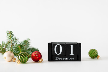 December 1st. Day 1 of december month, calendar with christmas balls decoration and fir branches on white background. Winter time. Empty space for text. New year, hello winter holidays concept