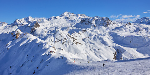 Panoramic view of the mountain range behind ski slope near Tignes high-altitude ski resort in France during the winter season.