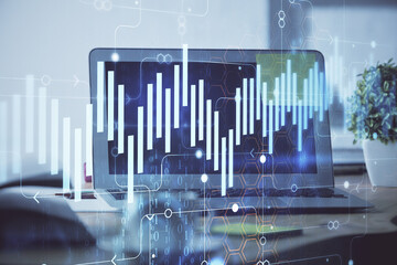 Stock market graph on background with desk and personal computer. Multi exposure. Concept of financial analysis.