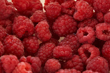 Fresh juicy ripe raspberry fruit, close-up, background.