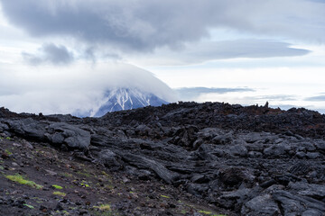 Lava on the background of the Ostry Tolbachik volcano in Kamchatka. - obrazy, fototapety, plakaty