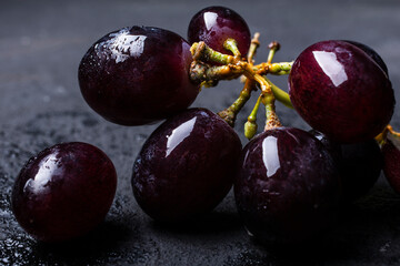 stem with grains of black table grapes