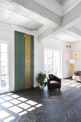 Chic, luxurious guest room design with old-fashioned antique furniture. white walls are decorated with relief. there is a beautiful dark brown parquet on the floor.