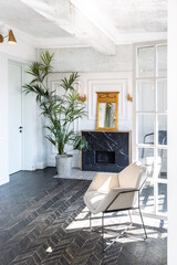 Chic, luxurious guest room design with old-fashioned antique furniture. white walls are decorated with relief. there is a beautiful dark brown parquet on the floor.