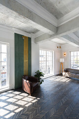 Chic, luxurious guest room design with old-fashioned antique furniture. white walls are decorated with relief. there is a beautiful dark brown parquet on the floor.